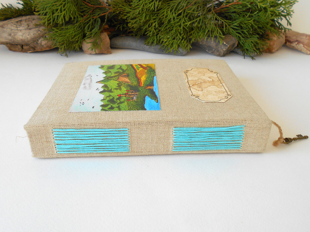 This is a handmade journal with linen fabric hardcovers and a fineÉaster Island heads art print on the front and also an empty coffee-stained title label so you can write your title on it. The art is from my art collection and is titled &#39;Balkatraz Castle&#39;. This journal is an inspirational book for you to use on the travel, for your daily diary journaling, or also for your planning and sketching of new projects and new poetry or novels.