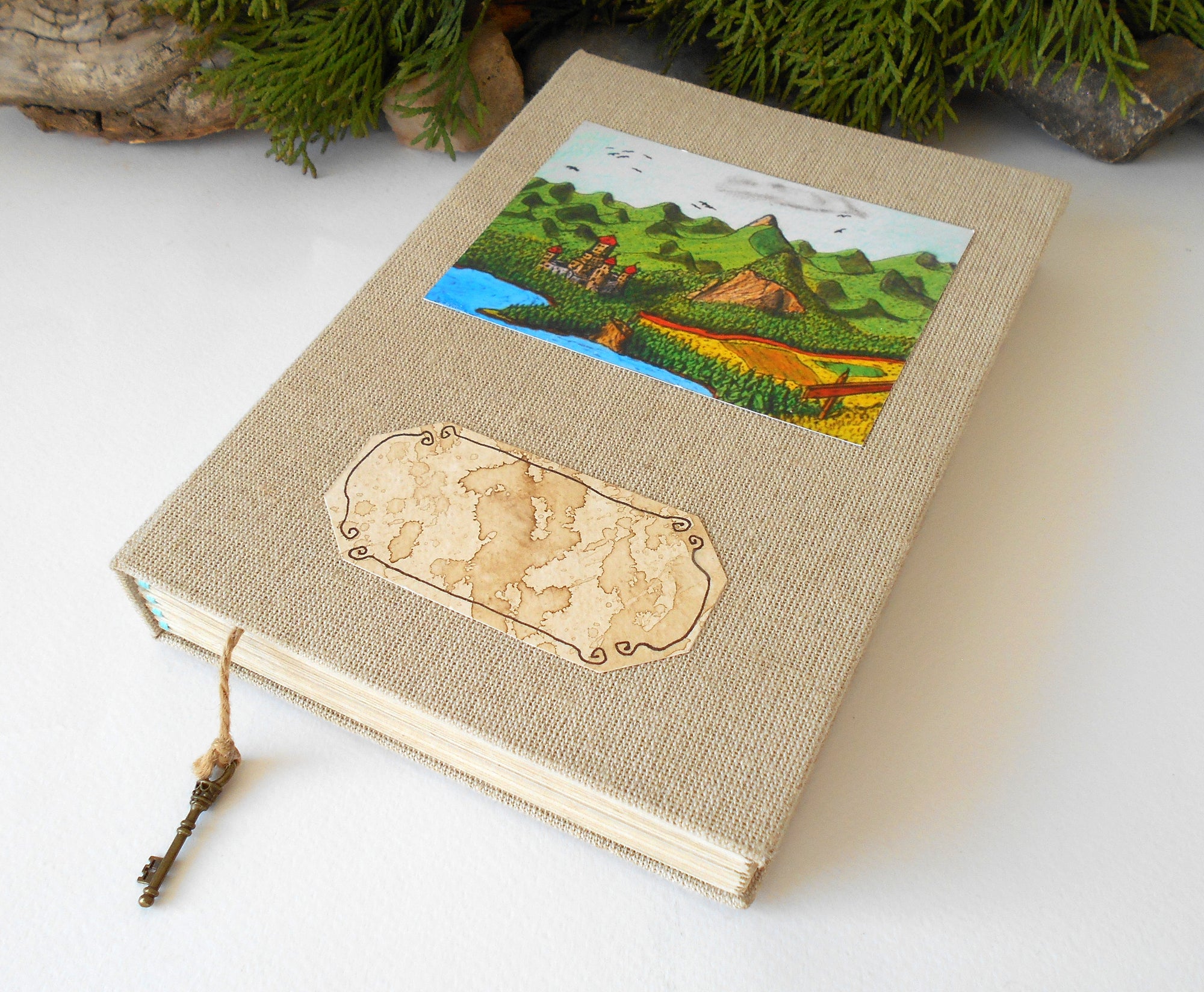 This is a handmade journal with linen fabric hardcovers and a fineÉaster Island heads art print on the front and also an empty coffee-stained title label so you can write your title on it. The art is from my art collection and is titled 'Balkatraz Castle'. This journal is an inspirational book for you to use on the travel, for your daily diary journaling, or also for your planning and sketching of new projects and new poetry or novels.
