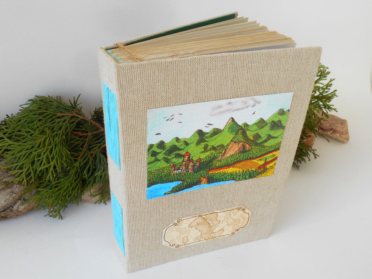This is a handmade journal with linen fabric hardcovers and a fineÉaster Island heads art print on the front and also an empty coffee-stained title label so you can write your title on it. The art is from my art collection and is titled &#39;Balkatraz Castle&#39;. This journal is an inspirational book for you to use on the travel, for your daily diary journaling, or also for your planning and sketching of new projects and new poetry or novels.