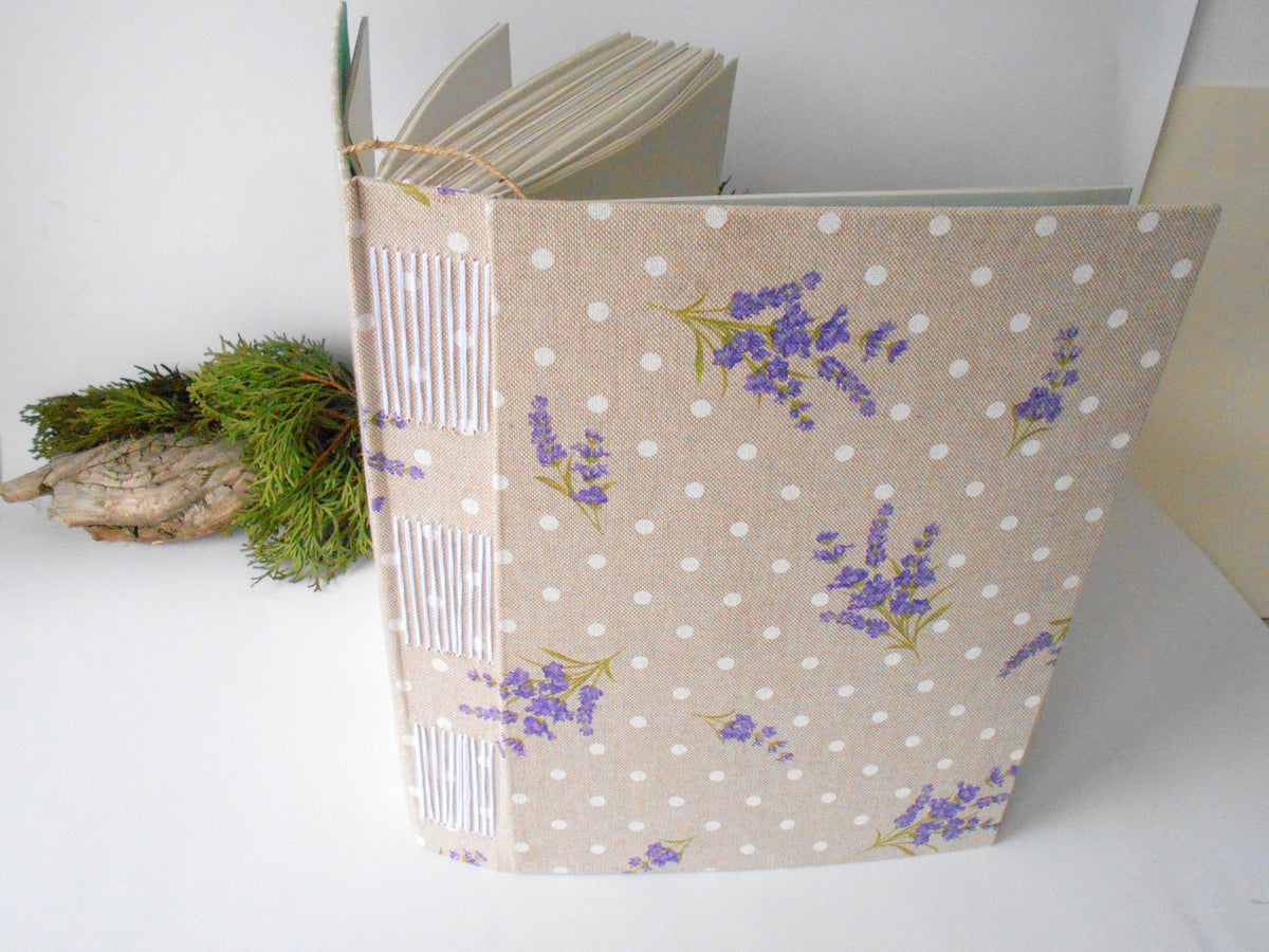 This is a handmade journal with Lavender cotton fabric hardcovers with Long-stitch triple binding that you can personalize in color. 