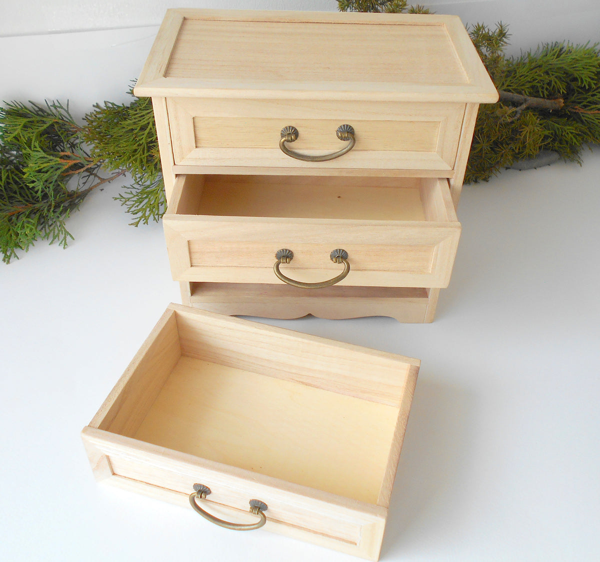 This wooden box with 3 drawers is made of bamboo wood. It has metal pulls with a vintage bronze color. The surface of the box is smooth and refined with sanding paper. The color of the box is plain pinewood color.&amp;nbsp;