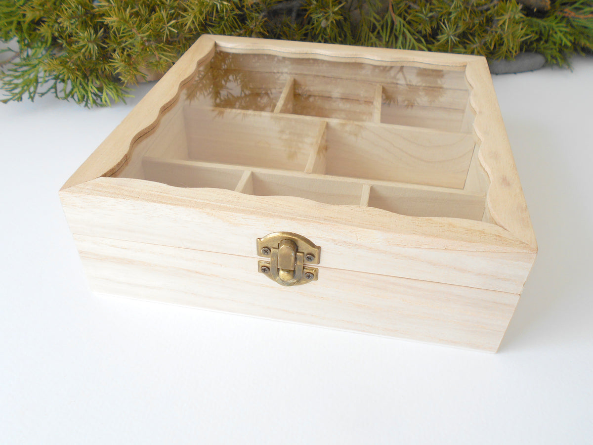 This is a wooden box with a glass display that is made of bamboo wood and that has metal hinges and closes with a bronze-color closing that may display various things like jewelry, miniatures, crystals, or other small objects of importance to you or your friends.