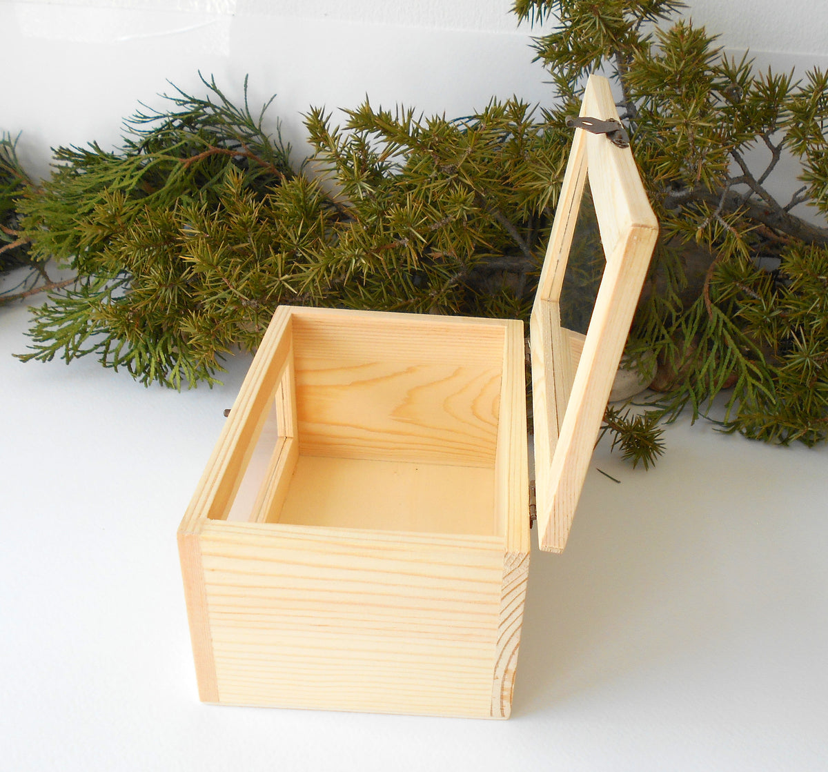 This small wooden display box is made of pinewood and has metal hinges with bronze color and the cap has a glass display so you can see what it&#39;s inside. There is another window on the front side of the box too. It has thick wooden walls and is quality made with fine pine wood materials.