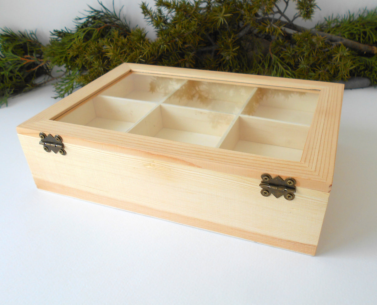 &lt;p&gt;This is a wooden box with a glass display that is made of pinewood and that has metal hinges and closes with a bronze-color closing that may display various things like jewelry, miniatures, crystals, or other small objects of importance to you or your friends.&lt;/p&gt; &lt;p&gt;The box is with 11 compartments on 2 levels- 6 compartments on the top level and 5 compartments on the bottom level.&lt;/p&gt;