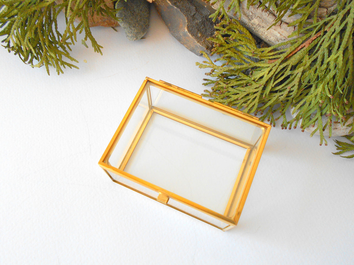This is a small glass box made of real glass and metal edges and metal hinges that closes with a gold-color closing that may display various things like jewelry, miniatures, crystals, or other small objects of importance to you or your friends. It can be used for tiny or small terrarium projects. The edges of the box are also gold-color metal pieces.&amp;nbsp;