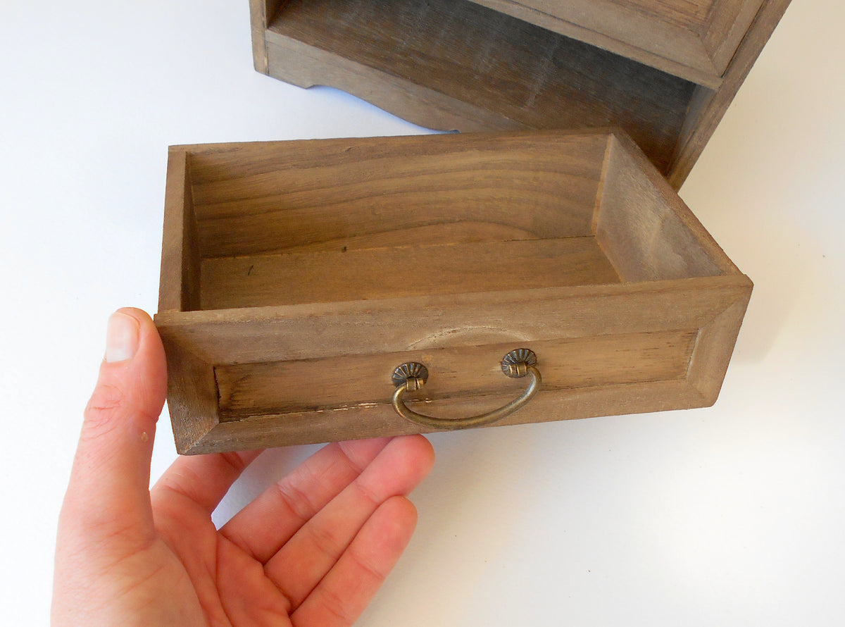 This wooden box with 3 drawers is made of bamboo wood. It has metal pulls with a vintage bronze color. The surface of the box is smooth and refined with sanding paper.