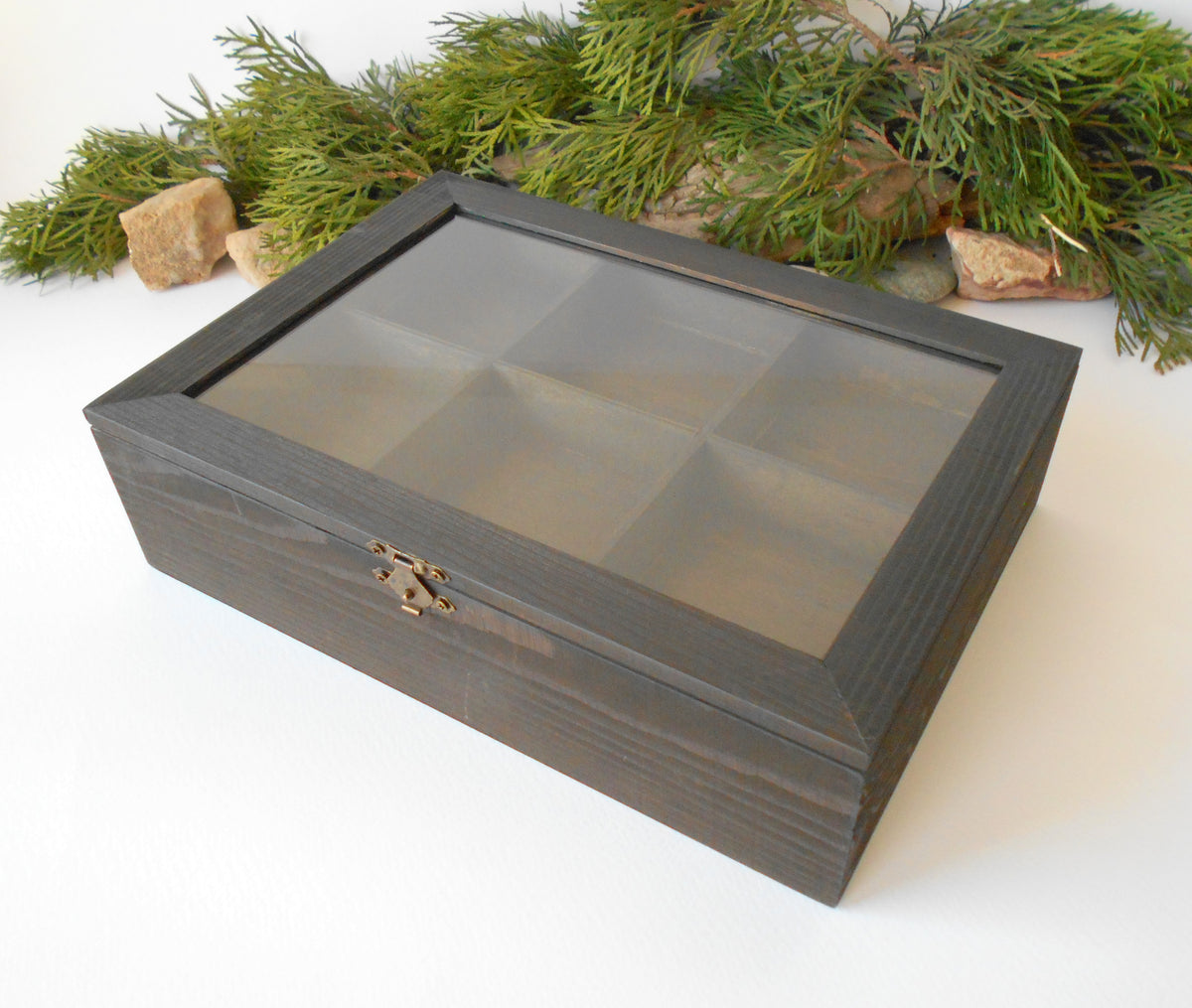 This is a wooden box with a glass display that is made of pinewood and that has metal hinges and closes with a bronze-color closing that may display various things like jewelry, miniatures, crystals, or other small objects of importance to you or your friends. &lt;span&gt;I have colored the box with mordant so that it looks like an old wood vintage box with a dark brown color.&lt;/span&gt;