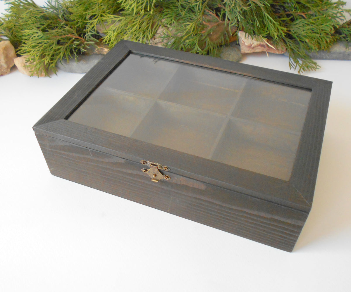 This is a wooden box with a glass display that is made of pinewood and that has metal hinges and closes with a bronze-color closing that may display various things like jewelry, miniatures, crystals, or other small objects of importance to you or your friends. &lt;span&gt;I have colored the box with mordant so that it looks like an old wood vintage box with a dark brown color.&lt;/span&gt;