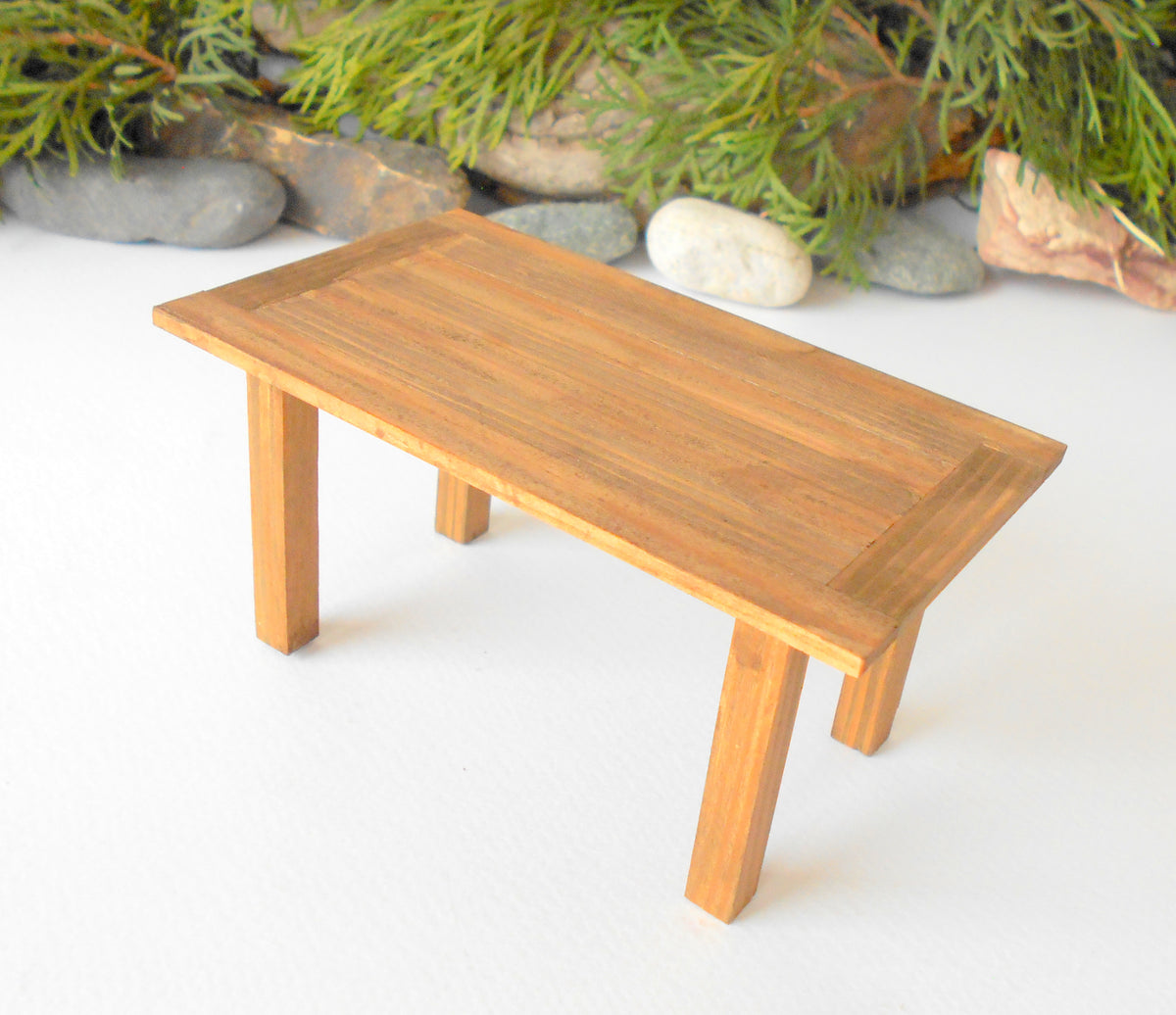 This is a handmade miniature dining or kitchen table on a&amp;nbsp;&lt;span data-mce-fragment=&quot;1&quot;&gt;1/12&lt;/span&gt;&lt;span data-mce-fragment=&quot;1&quot;&gt;th&lt;/span&gt; scale that is suitable for 6 mini chairs on a 1/12th scale. I handmade this table on order with real pine wood boards and beams and with water-based eco-friendly glue. I have stained that table with Italian eco-friendly mordant in light brown.