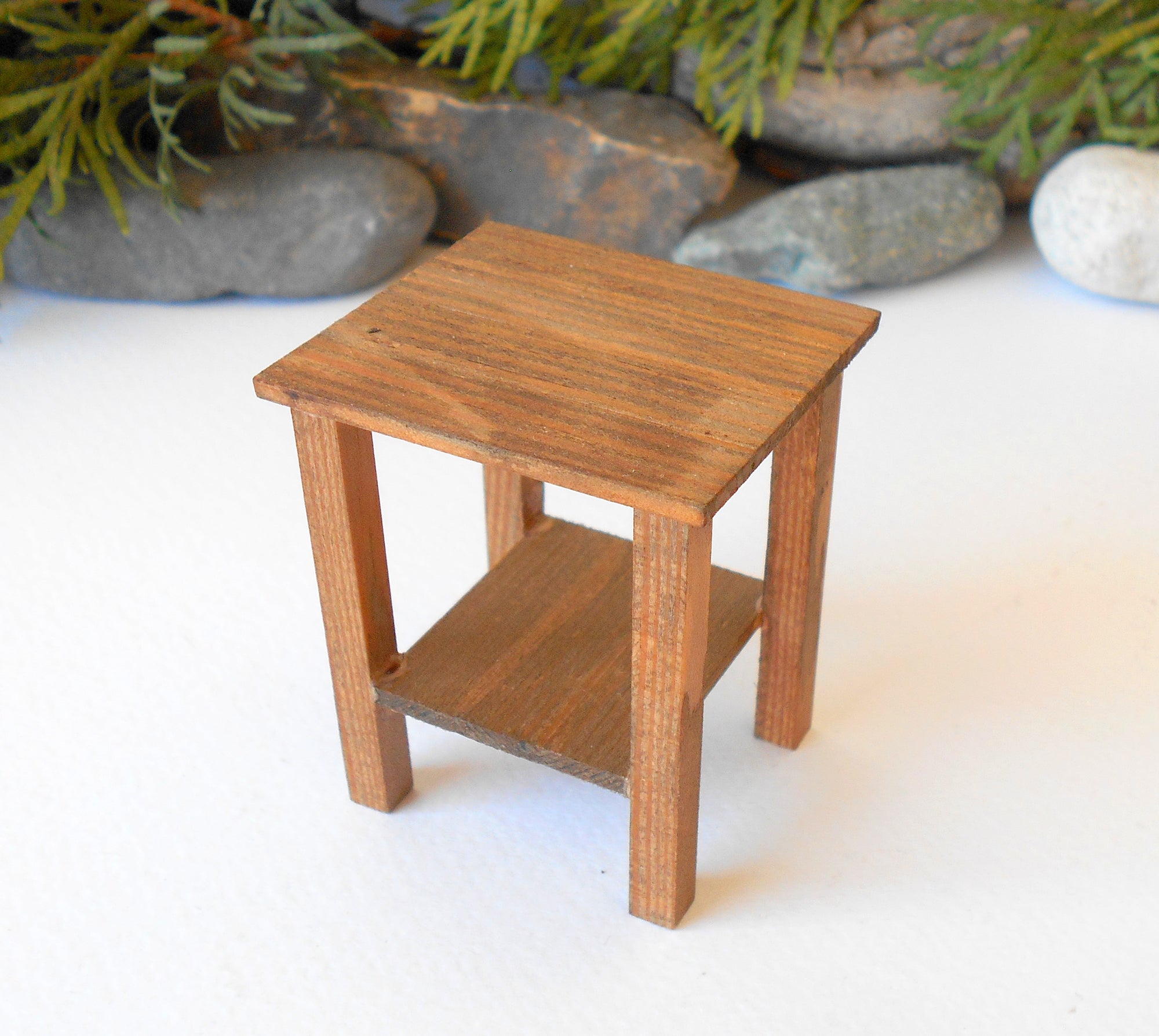 This is a Miniature nightstand or plant stand table of wooden furniture that is approximately 1/12 in scale. I have stained the mini nightstand with an Italian eco-friendly mordant in light brown.