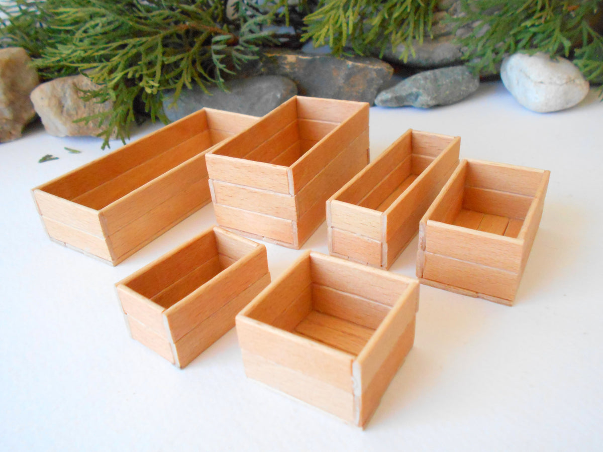 This is a set of 6 miniature boxes that are in 1/12 in scale. I craft them on order from beech popsicle sticks that I saved from being thrown away when I worked in an Ice cream factory in the Netherlands in 2023. The set consists of 6 different boxes. Read below for sizes.