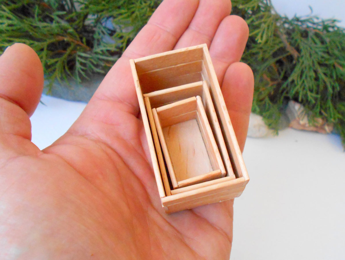 This is a set of 3 miniature boxes that are in 1/12 in scale. I craft them on order from beech popsicle sticks that I saved from being thrown away when I worked in an Ice cream factory in the Netherlands in 2023. The set consists of 1 big rectangular box, 1&amp;nbsp; medium rectangular box, and one small rectangular box.