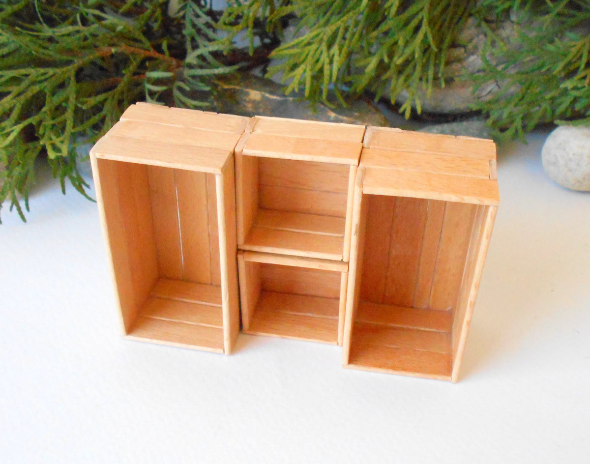 This is a set of 4 miniature boxes that are in 1/12 in scale. I craft them on order from beech popsicle sticks that I saved from being thrown away when I worked in an Ice cream factory in the Netherlands in 2023.