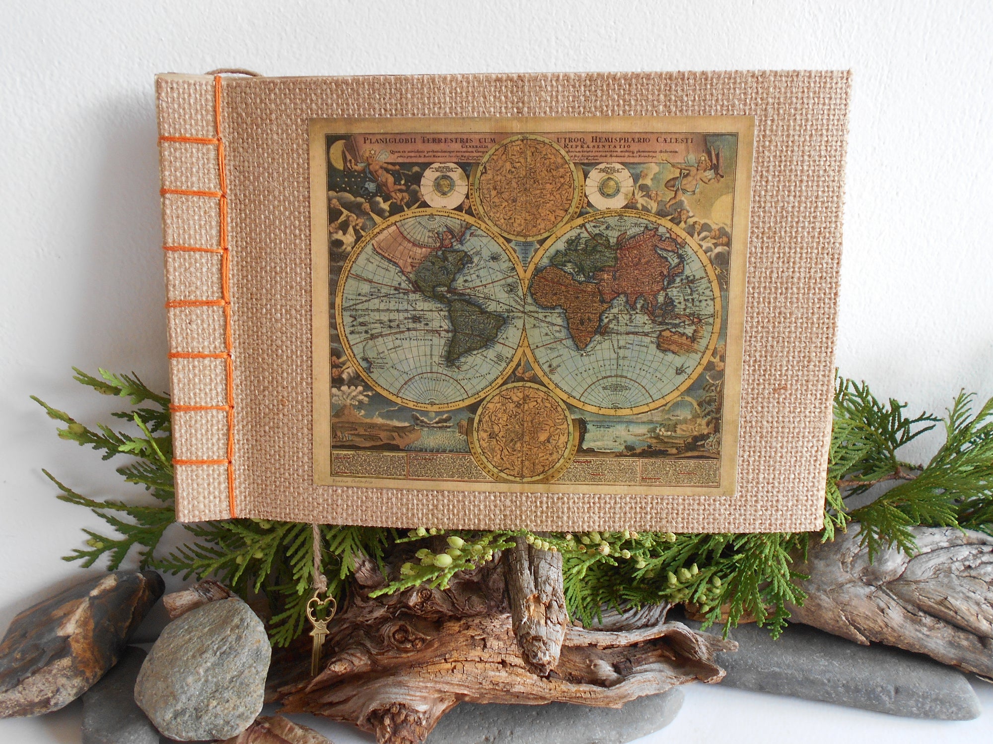 Handmade travel sketchbook with burlap covers and a fine old world map print on the front cover and bound with Japanese stab binding with an orange thread and a bookmark by ExiArts eco-friendly company from Bulgaria.
