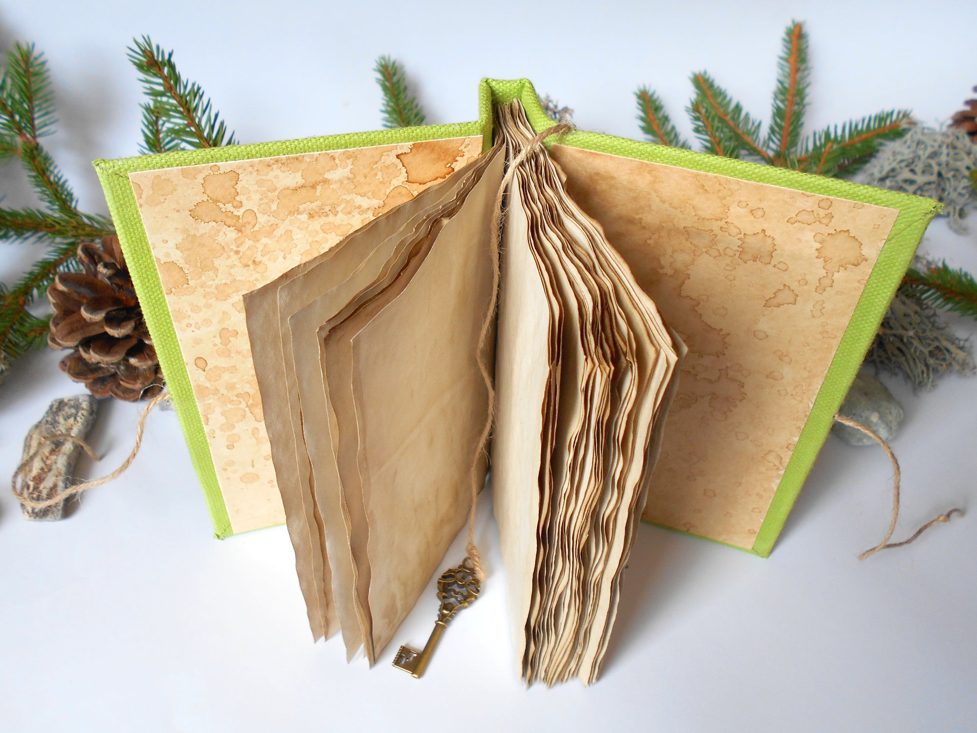 Handmade journal with coffee stained 100% recycled pages and green linen fabric hardcovers by ExiArts from Bulgaria