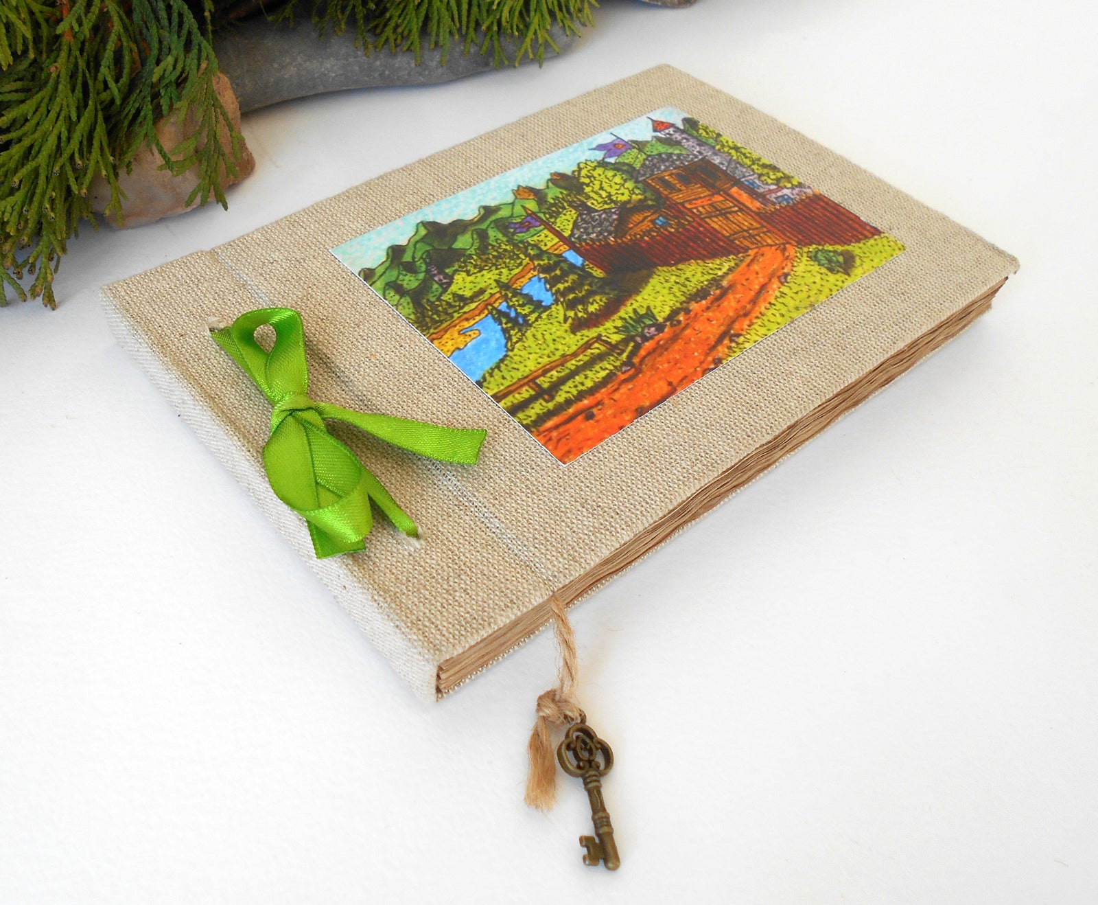 This is a refillable fabric sketchbook journal with a lash-down satin ribbon binding. You can personalize the color of this ribbon and the inside cover lining too. Read below for more information.  On the sketchbook cover, I have strongly glued with eco-friendly adhesive one of my art prints on a high-quality archival card stock. The fine art print from my art collection is titled 'Monithaal Encampment' and I drew it in 2014. 