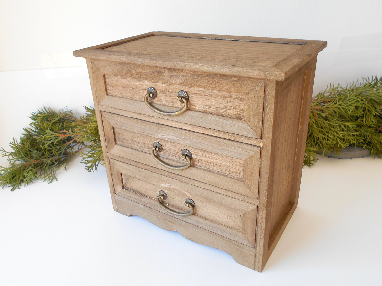 This wooden box with 3 drawers is made of bamboo wood. It has metal pulls with a vintage bronze color. The surface of the box is smooth and refined with sanding paper.