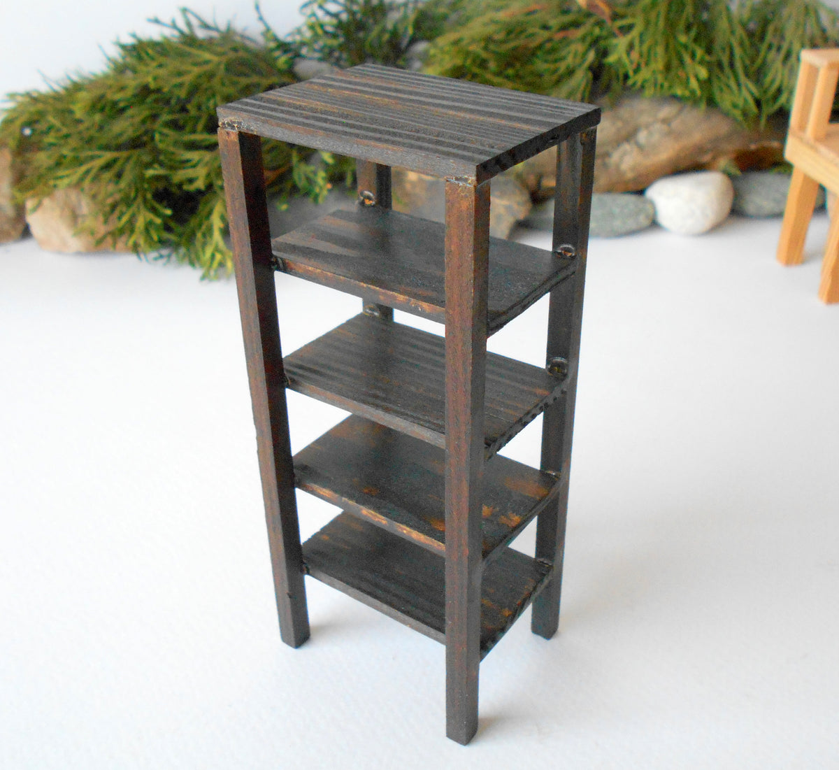 This is a Miniature shelf of wooden furniture that is approximately 1/12 in scale. I have stained the shelf with dark brown Italian eco-friendly mordant.&amp;nbsp;  This is a listing to purchase one such shelf like the one you see in the pictures. This mini&amp;nbsp;rack is crafted with eco-friendly glue and&amp;nbsp;pine wood fine and smoothed sticks.