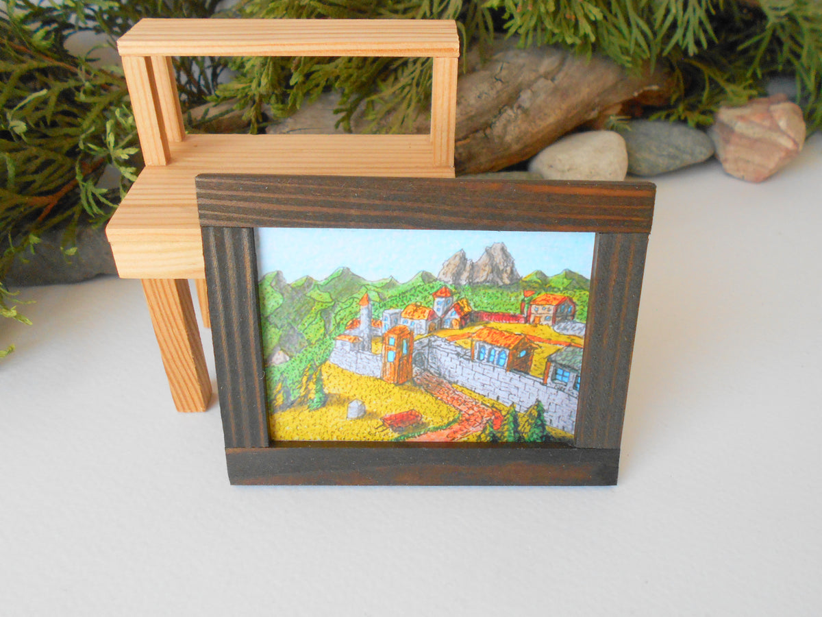 This is a miniature art framed with real pinewood that can decorate your dollhouse projects or your architectural models. If you know a passionate collector of miniatures you can make him or her a gift with one tiny framed art from an independent artist.