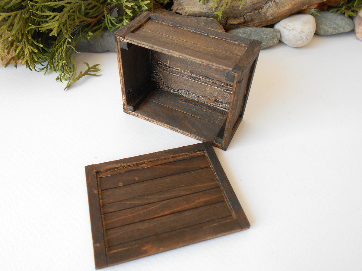 This is a miniature transporting box coffer that is approximately 1/12 in scale. The box coffer has 3 wooden boards in height and four boards in width on each side. This is a listing to purchase one such miniature box like the one you see from the pictures. I have stained the box in dark brown with an Italian eco-friendly mordant.&amp;nbsp;