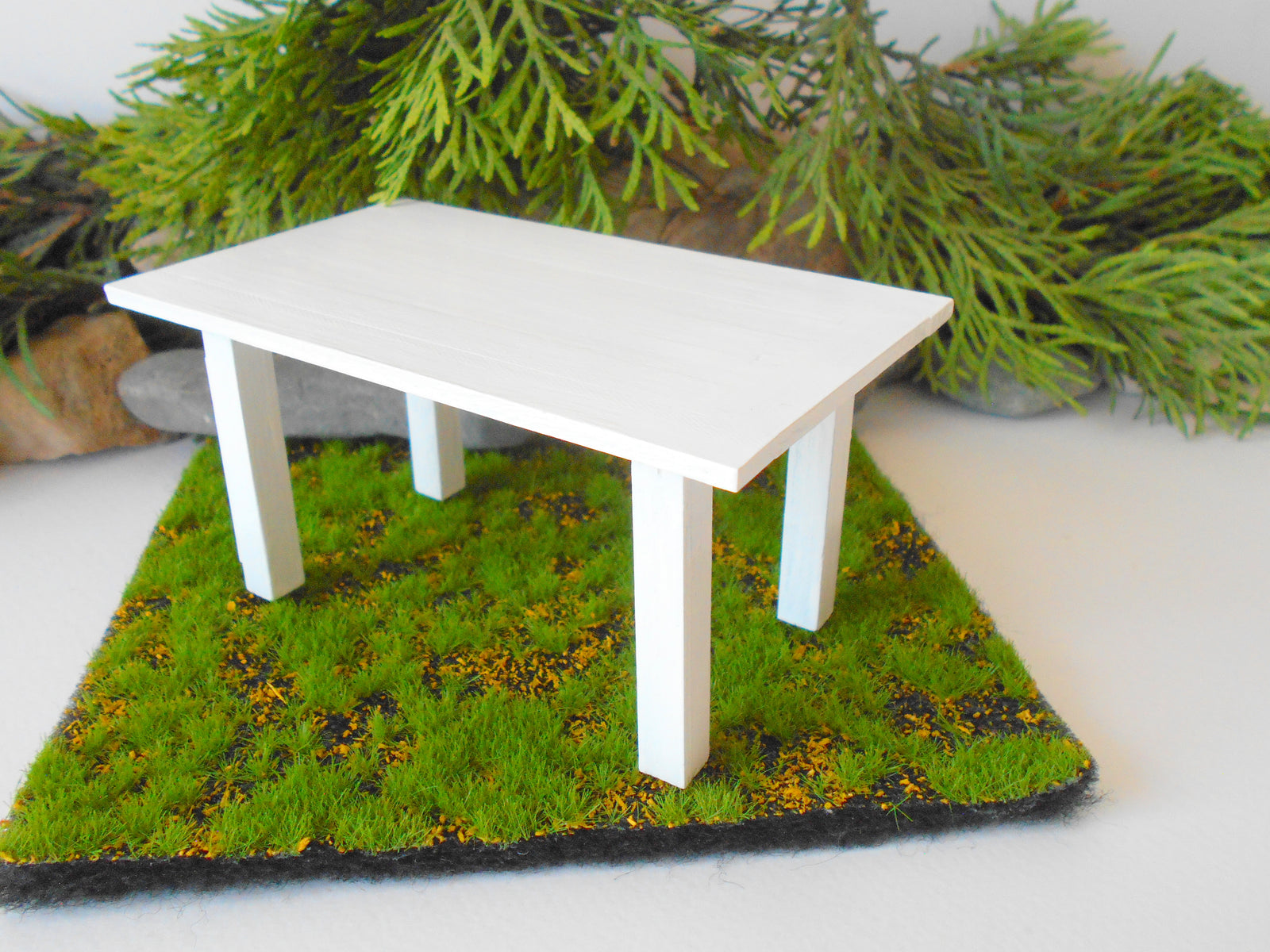 This is a handmade miniature dining or kitchen table on a&nbsp;1/12th scale that is suitable for 6 mini chairs on a 1/12th scale. I handmade this table on order with real pine wood boards and beams and with water-based eco-friendly glue. I have painted the table with white acrylic paints with a smooth shiny finish.