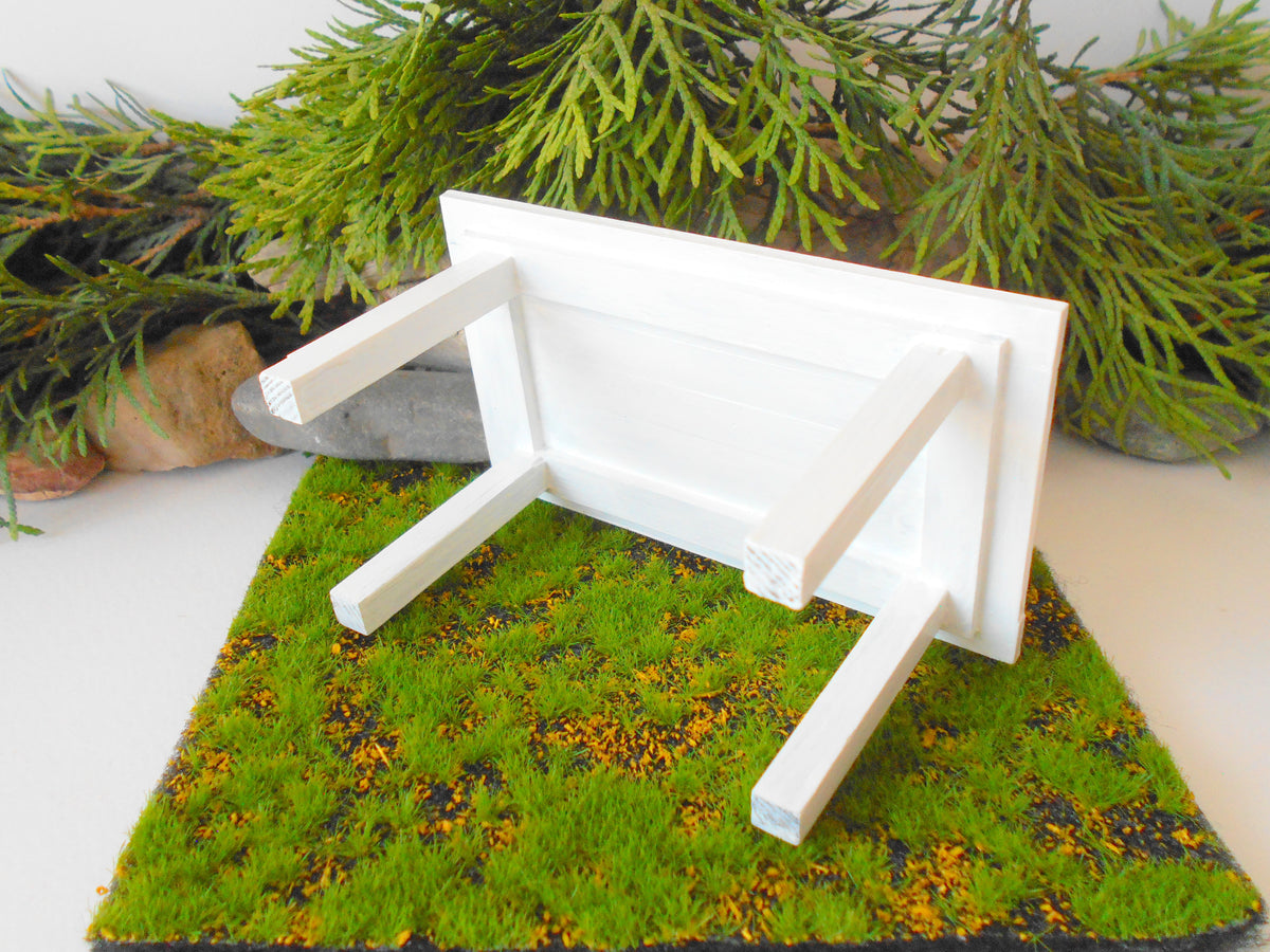 This is a handmade miniature dining or kitchen table on a&amp;nbsp;1/12th scale that is suitable for 6 mini chairs on a 1/12th scale. I handmade this table on order with real pine wood boards and beams and with water-based eco-friendly glue. I have painted the table with white acrylic paints with a smooth shiny finish.