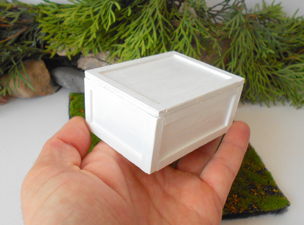 This is a miniature transporting box coffer that is approximately 1/12 in scale. The box coffer has 3 wooden boards in height and four boards in width on each side. This is a listing to purchase one such miniature box like the one you see from the pictures. I have painted the box in white with acrylic paint.&amp;nbsp;