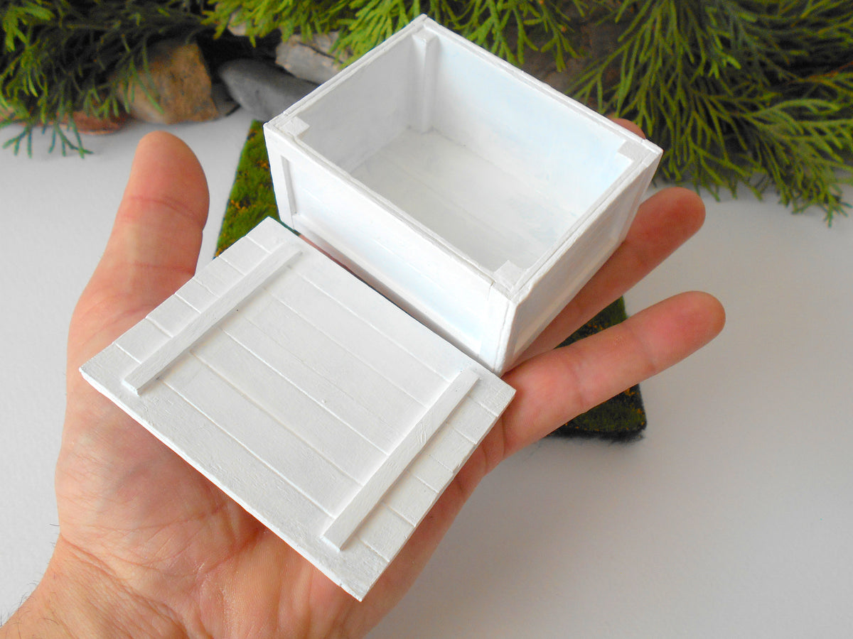 This is a miniature transporting box coffer that is approximately 1/12 in scale. The box coffer has 3 wooden boards in height and four boards in width on each side. This is a listing to purchase one such miniature box like the one you see from the pictures. I have painted the box in white with acrylic paint.&amp;nbsp;