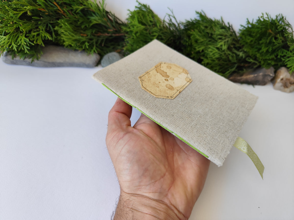 A gray handmade fabric notebook with a title label, a bookmark, Hemp Cord binding and coffee inside lining. The notebook is eco-friendly with linen gray fabric and Hemp cord as well as 100% recycled off-white blank pages.

NOTE: this is a listing for one notebook and shipping is included in the price.

Size: 5&quot; x 7&quot; ( 12.5 x 17.5 cm. )

Page number: 50 sheets - 100 pages

Color: hray

Page paper: 100 % recycled, off-white and blank pages