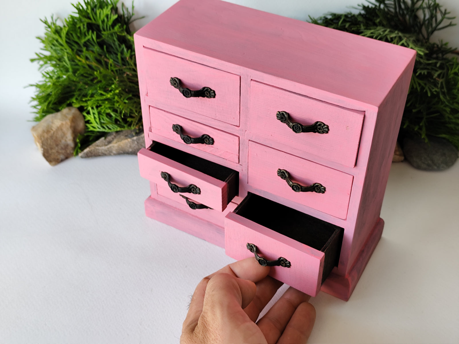  pink wooden box with 7 drawers is made of pinewood. It has metal pulls with a vintage bronze color. The surface of the box is smooth and refined with sanding paper. I have colored the box with mordant so that it looks like an old wood vintage box with pink acrylic paint.
 You can use the box as an Apothecary Cabinet, Desktop organizer, or makeup storage. You could store the small drawers of beads, jewelry, and other small things