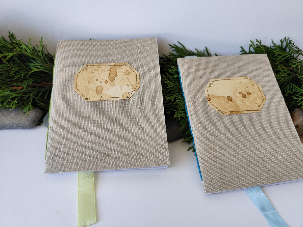 A gray handmade fabric notebook with a title label, a bookmark, Hemp Cord binding and coffee inside lining. The notebook is eco-friendly with linen gray fabric and Hemp cord as well as 100% recycled off-white blank pages.

NOTE: this is a listing for one notebook and shipping is included in the price.

Size: 5&quot; x 7&quot; ( 12.5 x 17.5 cm. )

Page number: 50 sheets - 100 pages

Color: hray

Page paper: 100 % recycled, off-white and blank pages
