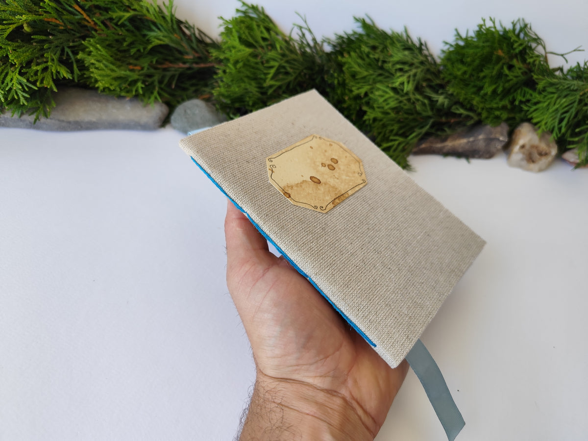 A gray handmade fabric notebook with a title label, a bookmark, Hemp Cord binding and coffee inside lining. The notebook is eco-friendly with linen gray fabric and Hemp cord as well as 100% recycled off-white blank pages.

NOTE: this is a listing for one notebook and shipping is included in the price.

Size: 5&quot; x 7&quot; ( 12.5 x 17.5 cm. )

Page number: 50 sheets - 100 pages

Color: hray

Page paper: 100 % recycled, off-white and blank pages