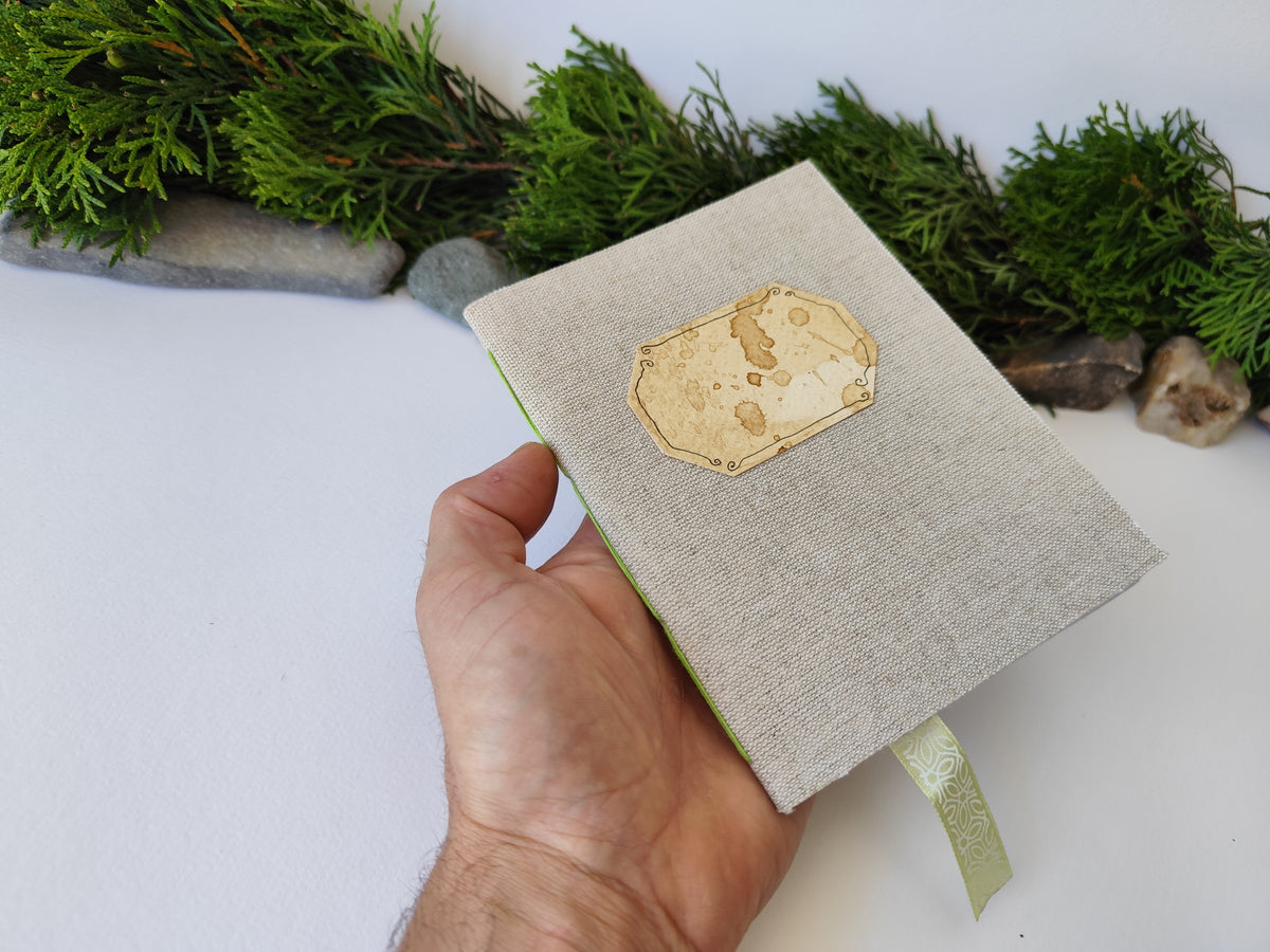 A gray handmade fabric notebook with a title label, a bookmark, Hemp Cord binding and coffee inside lining. The notebook is eco-friendly with linen gray fabric and Hemp cord as well as 100% recycled off-white blank pages.

NOTE: this is a listing for one notebook and shipping is included in the price.

Size: 5&quot; x 7&quot; ( 12.5 x 17.5 cm. )

Page number: 50 sheets - 100 pages

Color: hray

Page paper: 100 % recycled, off-white and blank pages