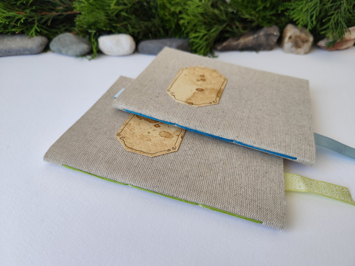 A gray handmade fabric notebook with a title label, a bookmark, Hemp Cord binding and coffee inside lining. The notebook is eco-friendly with linen gray fabric and Hemp cord as well as 100% recycled off-white blank pages.

NOTE: this is a listing for one notebook and shipping is included in the price.

Size: 5&quot; x 7&quot; ( 12.5 x 17.5 cm. )

Page number: 50 sheets - 100 pages

Color: hray

Page paper: 100 % recycled, off-white and blank pages